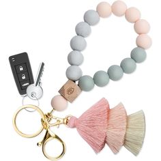 two bracelets, a keychain and a pair of scissors on a white background