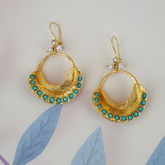 We produce our  jewelery in Istanbul. We use semi precious gemstones and brass covered with 18k-24k  gold. Their nature may cause gemstones to be in different shapes and color. Do not forget to explore more pieces using the link below. https://www.etsy.com/shop/FndJewelry  THANK YOU🤍 We are so grateful you have chosen FndJewelry. We love sharing happiness with you, it is only real when shared! Gold Natural Stones Drop Pearl Earrings, Turquoise Round Hallmarked Earrings, Turquoise Hallmarked Earrings For Gift, Gold-plated Earrings With Natural Stones, Gold Plated Earrings With Natural Stones, Gold Plated Gemstone Temple Jewelry Earrings, Elegant Gold Hoop Earrings With Natural Stones, Handmade Yellow Gold Temple Jewelry Earrings, Turquoise Natural Stone Hoop Earrings As Gift