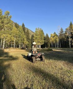 a man riding on the back of an atv