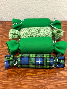 three green and blue items sitting on top of a wooden table