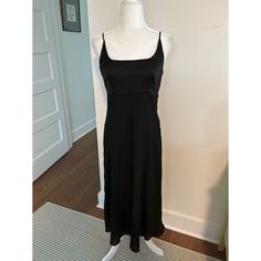 Top Of Dress Is Satin-Like Fitted Black Lined Slip Dress, Black Fitted Lined Slip Dress, Black Bias Cut Maxi Dress For Date Night, Black Silk A-line Maxi Dress, Black Maxi Length Bias Cut Dress, Flowy Solid Midi Dress For Evening, Black Maxi Dress With Bias Cut, Sleeveless Black Bias Cut Dress, Black Sleeveless Bias-cut Dress