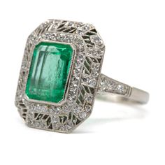 The Daphne ring was handmade in platinum and centers one natural Colombian emerald that weighs 2.70ctw which is surrounded by 76 old mine cut diamonds of H color and VS1 clarity that weigh 0.70ctw. This ring is currently size 7 and can be sized. Total weight: 6.3 grams/ 4dwt Ring measurement: 19mm by 16mm by 7mm Green Platinum Ring With Pavé Setting, Green Platinum Rings With Pave Setting, Platinum Emerald Ring With Pave Setting As Gift, Octagon Platinum Emerald Ring, Silver Emerald Cut Ring With Pave Setting, Silver Platinum Emerald Ring With Pave Setting, Heirloom Platinum Emerald Ring, Gia Certified, Heirloom Emerald Ring In Platinum, Heirloom Platinum Emerald Gemstone Ring