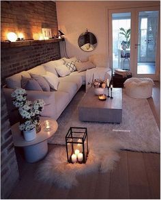 a living room filled with lots of furniture and candles on top of the coffee table