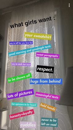 the words are written in different colors on the window sill and behind it is a white lamp