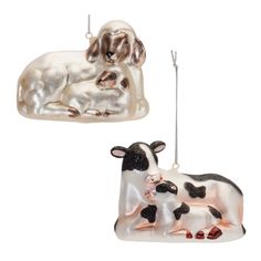 two glass ornaments depicting cows and a dog on a white background, one in the shape of a rectangle ornament