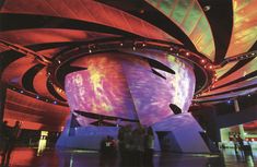 people are standing in front of a colorful ceiling