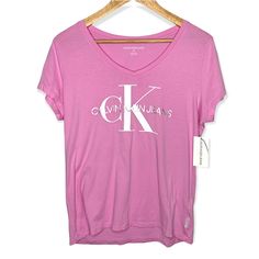 This Is New With Tags Calvin Klein Pink V Neck Logo T-Shirt. The Size Is Large. Measurements: Pit To Pit: 18" Length: 25" Feel Free To Offer! Bundle And Save! All My Items Come From A Smoke-Free Home :) All My Orders Ship Out Monday-Friday. Thanks For Looking! Calvin Klein Crew Neck T-shirt For Spring, Calvin Klein Graphic Tee Short Sleeve, Calvin Klein Graphic Tee Short Sleeve T-shirt, Calvin Klein Graphic Tee With Short Sleeves, Calvin Klein Short Sleeve Graphic T-shirt, Calvin Klein Summer T-shirt With Logo Print, Calvin Klein Logo Print T-shirt For Summer, Calvin Klein Graphic Print Relaxed Fit T-shirt, Calvin Klein Summer Logo Print Top