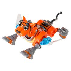 an orange and gray toy dog with large eyes on it's back legs, sitting in front of a white background