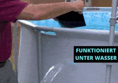 a man is washing his hands in a large blue tub with the words funtoniert under it