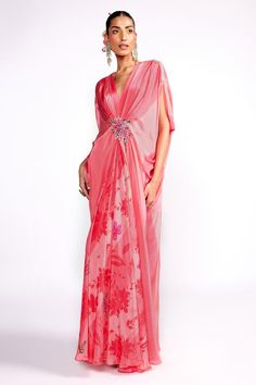 Flamingo pink draped kaftan with floral print, highlighted with floral embroidery on the waistband.
Components: 1
Pattern: Print, Embroidery
Type Of Work: Floral
Neckline: V Neck
Sleeve Type: Split Sleeves
Fabric: Crepe, Lining: Crepe
Color: Pink
Other Details: 

Model height: 5ft 8 inches, wearing size S
Note: Hair accessory worn by the model is not for sale
Occasion: Resort - Aza Fashions Pink Designer Dress With Cape Sleeves, Designer Pink Dress With Cape Sleeves, Pink Floor-length Kaftan For Festive Occasions, Pink Traditional Drape Dress For Spring, Pink Floor-length Festive Kaftan, Traditional Pink Dress For Spring, Pink Spring Dress With Traditional Drape, Bollywood Style Pink Saree Kaftan, Festive Pink Floor-length Kaftan