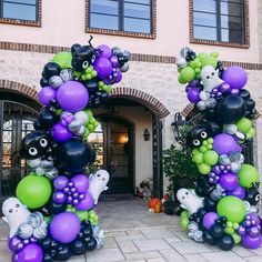 two large balloons are in the shape of animals and bats on display outside a building