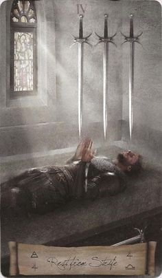 a person laying on the ground in front of swords and a stained glass window with writing underneath it