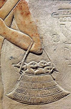 an ancient egyptian carving with a person holding a bowl