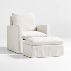 a white chair with a footstool sitting on it's back and legs