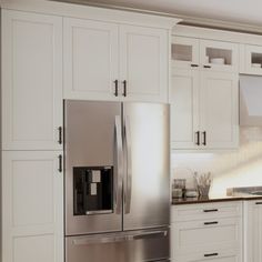 a stainless steel refrigerator in a white kitchen