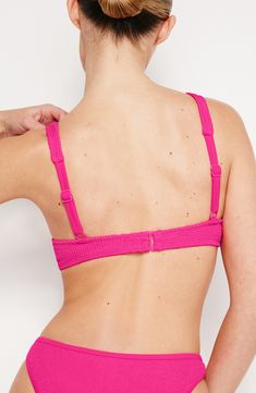 Created to fit every body, this shapely bikini top with a supportive underwire is designed to adapt to your body's changes for the perfect fit every time. Clasps at back Adjustable straps 95% polyester, 5% elastane Machine wash, dry flat Imported Black Owned/Founded Push-up Swimwear With Built-in Bra For Sunbathing, Pink Swimwear With Medium Bust Support For Summer, Underwire Swimwear With Medium Bust Support, Fitted Pink Swimwear With Medium Bust Support, Fitted Pink Swimwear With Bust Support, Fitted Swimwear With Underwire And Bra Friendly, Swimming Push-up Bra With Built-in Support, Push-up Bra For Swimming, Swim Bra With Removable Pads