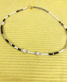 "Black and white Beaded choker necklace is handmade from the best materials. You can buy it as a gift for a friend, sister, mother. BEADS SIZE : The pearls are 6-8mm (0.23 - 0.31 inch), and the beads are 2-3mm (0.07 - 0.11 inch). MEASUREMENTS: Choose a length for your choker necklaces (measured in inches). Measure the length of your neck with a measuring tape or you can use any thread, rope, or cable for telephone and after apply the measurements to a regular ruler. If you have any questions abo White Single Strand Pearl Choker, Trendy White Pearl Necklace, Trendy White Choker For Gift, Trendy White Pearl Choker Necklace, Black Pearl Choker As Gift, Black Pearl Choker As A Gift, Black Pearl Choker Gift, White Pearl Single Strand Choker, White Tiny Beads Choker As Gift