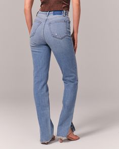 On-trend 90's-style ultra high rise straight jeans with built-in stretch for superior comfort featuring our highest rise that sits at your natural waist and looks great with your shirt tucked or untucked. With refined details and a vintage feel from top to bottom, this style features a longer-length inseam, medium light indigo wash and split-hem detail. High Rise Straight Jeans, Jean Crafts, Shirt Tucked In, Women's Bottoms, American Clothing, Abercrombie Kids, Chic Woman, American Apparel, 90s Fashion