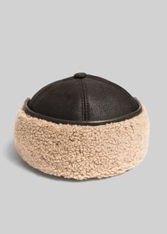 A true lambskin shearling cap, fully lined in twisted, curly Spanish merino. There's no glue involved – this is two sides of a natural hide. Lambskin's superior hand and temperature regulating properties keep this comfortable cap in play for the entire fall-winter. Size down for a tighter fit. SIZE STANDARD HAT SIZE CIRCUMFERENCE M 7 1/8 22.5'' L 7 1/2 23'' XL 7 3/4 23.5'' Aviator Cap, Aviator Hat, Trapper Hat, Trapper Hats, Hat Sizes, Big Size, Chestnut, Glue, Hats