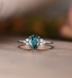 MADE TO ORDER * Material: Solid gold(14K/18K white/yellow/rose gold) * DETAILS  57411 Engagement ring - Center stone:Teal sapphire 5*7mm oval cut Side stone:Moissanite or diamond - diamond:0.15ct,Color G-H,Clarity SI-VS - moissanite:0.15ct * Click on the "Pin It" icon if you like this item * Custom Order We can make custom rings in almost any shape and style. If you want a specific model, please send us a clear picture and we will do our best.  * Shipping Most items take 2-3 weeks to create.I'm Sapphire Engagement Ring Oval, Flower Halo Engagement Ring, Blue Green Sapphire Ring, Oval Sapphire Engagement Ring, Future Days, Vintage Sapphire Ring, Black Onyx Engagement Ring