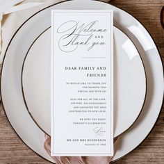 a table setting with plates and silverware, napkins and place cards on it