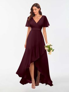 a bridesmaid in a long, deep purple dress with short sleeves and an asymmetrical skirt