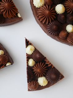 three pieces of chocolate cake with white and brown icing