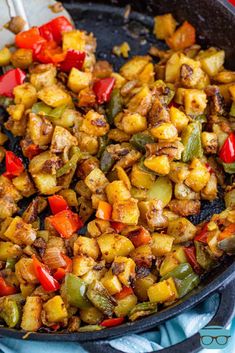 a skillet filled with cooked vegetables on top of a blue towel