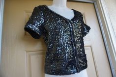 "What a Awesome top!! You'll be sure to catch everyone's attention when you show up to the party in this little number! All over sequin detailing makes this shirt ready for any night on the town. Made Cache. labeled Medium Good vintage condition. Measurements taken across front laid flat - stretchy 18\" across front armpit to armpit 15\" across waist 20\" length" Vintage Sequined Tops For Festive Occasions, Fitted Vintage Blouse With Sequins, Vintage Sequin Party Top, Fitted Vintage Sequin Blouse, Black Sequin Short Sleeve T-shirt, 90s Shirts, Womens Halter Tops, Goddess Dress, Levis Denim