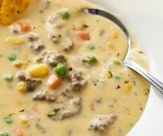 a close up of a bowl of soup with corn on the cob