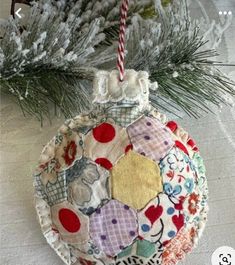 a patchwork ornament hanging from a christmas tree