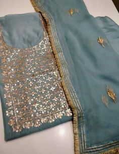 Item Overview ATHARVA Hand Embroidered Salwar Kameez w/Embroidery Neck Blue Grey w/Gota Patti Dupatta/Custom Stitch/Tunic/Pants/Patiala Salwar/ Dno. CH1485 Fabric: * Shirt Chanderi Silk - Embroidered Neck- Blue Grey - 2.5 Mts Beautiful Hand Embroidered Neck. * Dupatta: Chiffon Chinnon Dupatta- 2.5 Mts- Gota Patti work- Blue Grey * Bottom Santoon Silk 2.5 Mts. Excusive Hand Embroidered Party Wear Punjabi Suit. Customization: * Fabrics Customization: Designs Can be made in different Fabrics. *Colo Blue Georgette Sharara With Gota Work, Unstitched Designer Blouse Piece With Gota Work, Blue Georgette Anarkali Set With Gota Work, Unstitched Gota Work Blouse Piece For Designer Wear, Embroidered Georgette Sharara With Straight Kurta, Designer Blouse Piece With Sheer Dupatta For Eid, Blue Georgette Kurta With Sheer Dupatta, Designer Sheer Dupatta Blouse For Eid, Anarkali Unstitched Blouse Piece With Gota Work