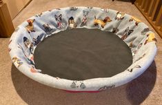 a dog bed with dogs on it in the middle of a room