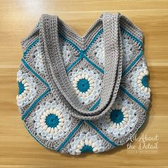 a crocheted bag sitting on top of a wooden floor