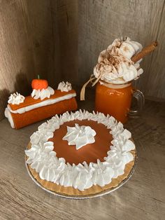 there is a cake and some whipped cream on the table with pumpkins in the background