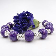 Harmoniously uniting the timeless elegance of flowers with contemporary design, our Harmony Bracelet is a truly unique piece of keepsake jewelry. This exquisite bracelet features 6 to 10 individually handcrafted flower infused beads, each holding your precious flower petals. Complimented by detailed sterling silver caps and interspersed silver beads, it's a blend of beauty and sentimental value. All components used in the earrings are crafted from sterling silver, ensuring a timeless and high-qu Elegant Beaded Bracelets With Large Beads As Gift, Elegant Large Bead Jewelry Gift, Elegant Large Beaded Jewelry Gift, Elegant Sterling Silver Bracelet With Spacer Beads, Elegant Silver Bracelets With Large Beads, Elegant Silver Bracelet With Large Beads, Elegant Purple Jewelry With Silver Beads, Elegant Adjustable Sterling Silver Bracelet With Spacer Beads, Elegant Beaded Bracelets With Flower-shaped Spacer Beads