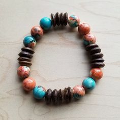 Add this adorable turquoise beaded bracelet to your boho chic jewelry collection! This handmade beaded bracelet features turquoise and wooden beads, creating a unique, earthy look. Beautiful and versatile, this beaded boho bracelet can be worn with any outfit. Stack this turquoise beaded bracelet with other boho accessories or wear it on its own. Although this handcrafted bracelet will resemble the photo, no two pieces of our boho fashion jewelry are identical. If you’re looking for the perfect Bracelet String, Wood Bead Bracelet, Turquoise Bead Bracelet, Coral Bracelet, Bohemian Accessories, Wood Bracelet, Boho Chic Jewelry, Boho Style Jewelry, Boho Accessories