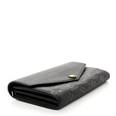 This is an authentic LOUIS VUITTON Empreinte Sarah Wallet NM in Black. This stylish Louis Vuitton wallet is crafted of monogram embossed leather in classic black. The wallet has a smooth grained leather envelope style flap that opens with a gold snap to an interior of matching leather with a zipper compartment, patch pockets and card slots. Leather Envelope, Louis Vuitton Empreinte, Louis Vuitton Wallet, Authentic Louis Vuitton, Embossed Leather, Classic Black, Patch Pocket, Card Slots, Slots