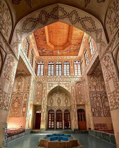 the inside of an old building with intricately painted walls and ceiling tiles on it