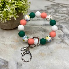 a bracelet that has some beads on it and a keychain attached to it