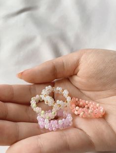 lula beads is here with a new collection of rings! These Daisy Rings are so cute and dainty and looks good layered with other rings. It comes in four different colors of flowers for fun and variety. - Glass seed beads - Sturdy string - Excess string might show on the end because it is handmade - Avoid water for colors might change ✿SHIPPING✿ Orders will be shipped as soon as possible but business days will be 2-3 days with an additional 3-5 days on shipping. We will try our best to send out our Sweet Beaded Jewelry For Gifts, Sweet Beaded Jewelry Gift, Handmade Sweet Jewelry With Beads, Cute Handmade Pink Rings, Sweet White Handmade Jewelry, Sweet Handmade White Jewelry, Cute Beaded Rings For Gifts, Cute Beaded Jewelry For Mother's Day, Delicate Pink Flower Ring For Gift