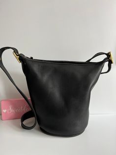 Vtg Coach Original  Helen's Legacy Duffle Bag Black leather with brass hardware Roomy interior with slip pocket Secured with a top zipper Detachable, adjustable 48" strap Measures: 11"H, 12.5"L, 7"W Made in Turkey #H6I-9953 Cleaned, conditioned and ready to wear! Questions? Just ask More vtg coach styles/colors also available g90 Classic Bucket Bag With Gold-tone Hardware For Travel, Classic Bucket-shape Shoulder Bag With Detachable Strap, Travel Bucket Bag With Gold-tone Hardware In Satchel Shape, Vintage Hobo Bag With Zipper For Travel, Rectangular Hobo Bag With Brass Hardware For Travel, Classic Bucket Shoulder Bag With Brass Hardware, Classic Bucket Bag With Brass Hardware, Classic Bucket Satchel With Detachable Strap, Classic Hobo Shoulder Bag With Brass Hardware