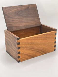 a wooden box with two compartments on the inside