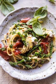 a white plate topped with pasta and vegetables