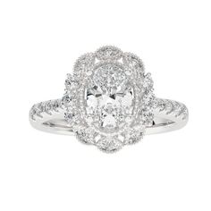 a white gold ring with an oval cut diamond surrounded by smaller round diamonds on the band