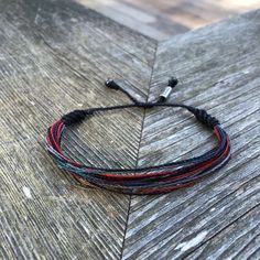 BLACK STRING BRACELET: This hand-knotted, unisex, multi-strand string bracelet includes two genuine Hematite stones and a Rumi Sumaq logo bead. In a masculine color combination of black, red, gray, plum, and turquoise it is a great bracelet for men. Purchase two or more as a symbol of solidarity with your brother, father or best friends. SIZING of BLACK THREAD BRACELET: The bracelet is custom made in all sizes from XS up to XL making this bracelet suitable for children and adults alike. The brac Black Thread Bracelet, Black String Bracelet, Boy Bracelet, Boys Bracelets, Sliding Knot Closure, Thread Bracelet, Bday Gift, Thread Bracelets, Hematite Stone