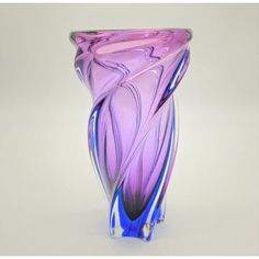 a purple glass vase sitting on top of a table