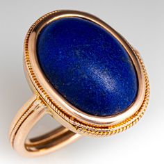 a gold ring with a blue stone in it