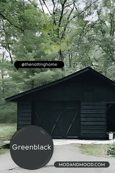 a black garage with the words greenblack over it and trees in the background