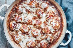 a pizza with meatballs and cheese in a pan